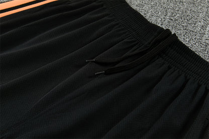 Conjunto Arsenal Entrenamiento Negro y Naranja 26/27