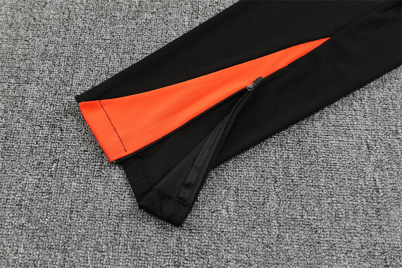 Chándal Brasil 2025/26 – Negro con detalles naranja