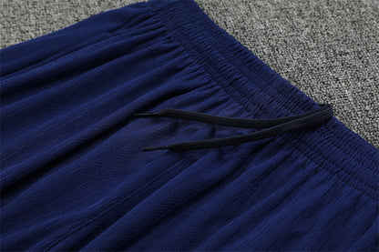 FC Barcelona 25/26 – Training Set (Azul marino con efecto wave naranja/blanco)