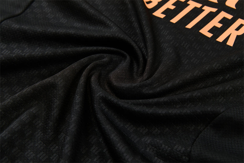 Conjunto Arsenal Entrenamiento Negro y Naranja 26/27
