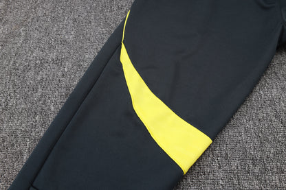 Chándal Real Madrid 2025/2026 – Negro con Detalles Amarillos